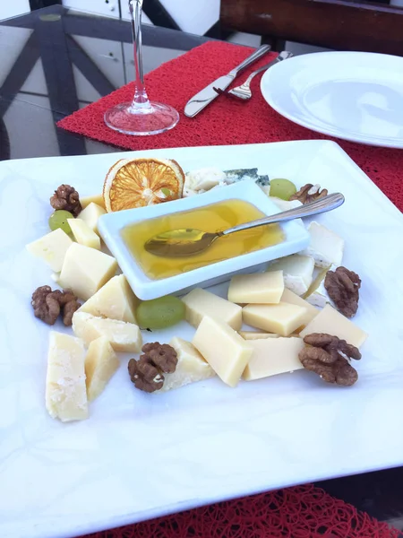 Cheese plate with honey and nuts — Stock Photo, Image