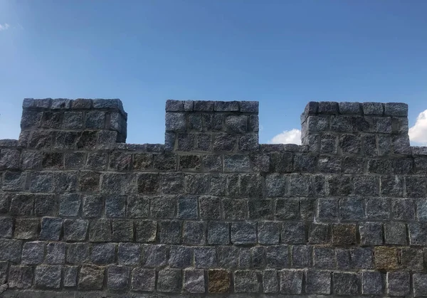 fortified castle wall on background blue sky