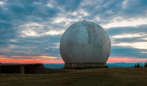 The old military facility is a tracking system. Radar base. Old giant dome of a radar antenna of a Ukrainian military base. Apocalyptic view.