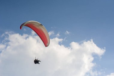 Yalnız yamaçparaşütü bulutlar arka planı mavi gökyüzünde uçan. Güneşli bir havada yamaç paraşütü. Yamaçparaşütü, Borzhavsky aralığı, Transcarpathia, Ukrayna uçuşlarında. 05 Haziran 2018.