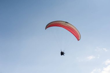 Yalnız yamaçparaşütü bulutlar arka planı mavi gökyüzünde uçan. Güneşli bir havada yamaç paraşütü. Yamaçparaşütü, Borzhavsky aralığı, Transcarpathia, Ukrayna uçuşlarında. 05 Haziran 2018.