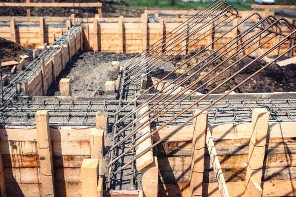 industrial details - construction site of new house, building. Foundation, cement and steel bar infrastructure reinforcement