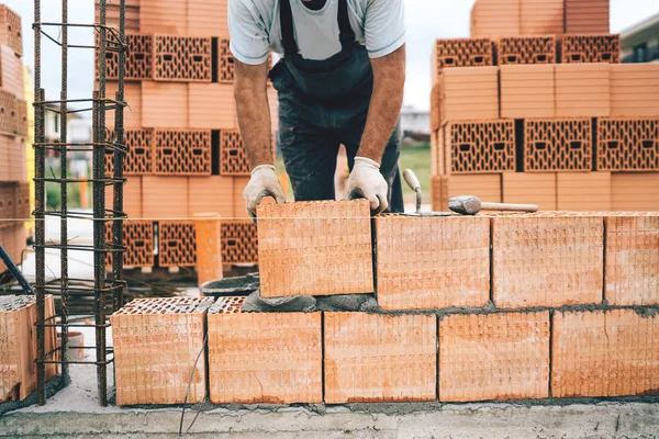 industrial worker, construction worker using modern bricks for brickwork, building walls