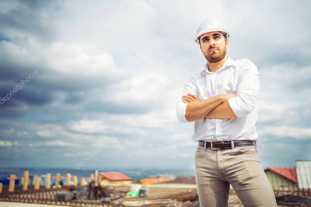 Portrait of young construction business developer, happy architect on building site