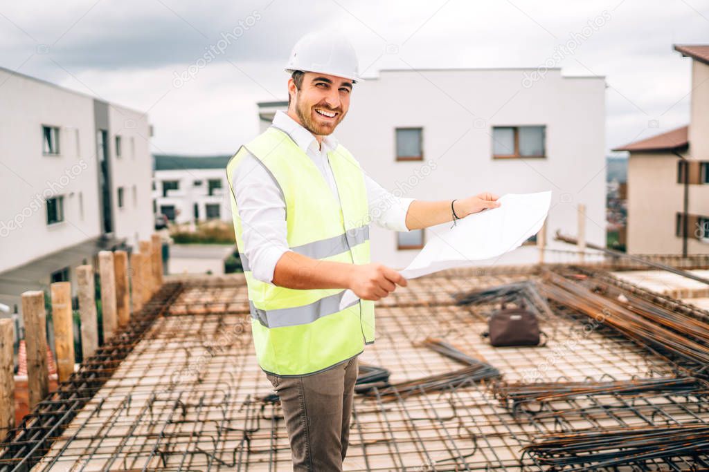 Portrait of confident and smiling man, engineer working on construction site