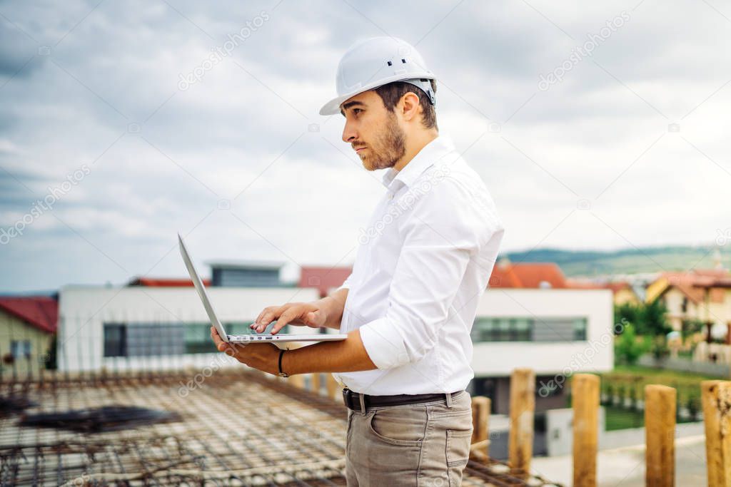 Portrait of young man, male working on construction site. Engineer, worker and architect concept
