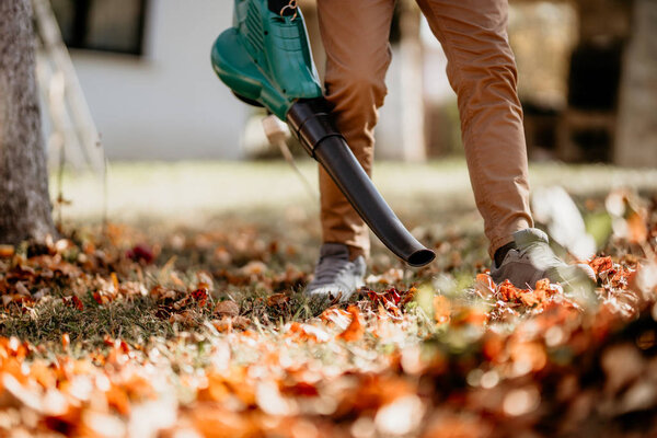 Professional gardener doing landscaping chores, close up of garden works