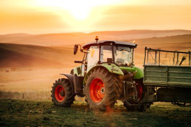 Details of farmer working in the fields with tractor on a sunset background. Agriculture industry details clipart