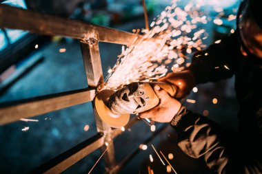 İnşaat sektöründe ve metal kesme diski açı öğütücü ile çalışan adam