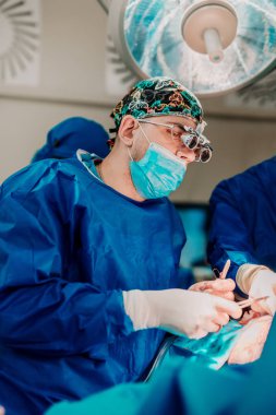 Ameliyathane cerrah portresi. Cerrah Scrubs, giyiyor koruyucu gözlük ve performans gösteren cerrahi eldiven