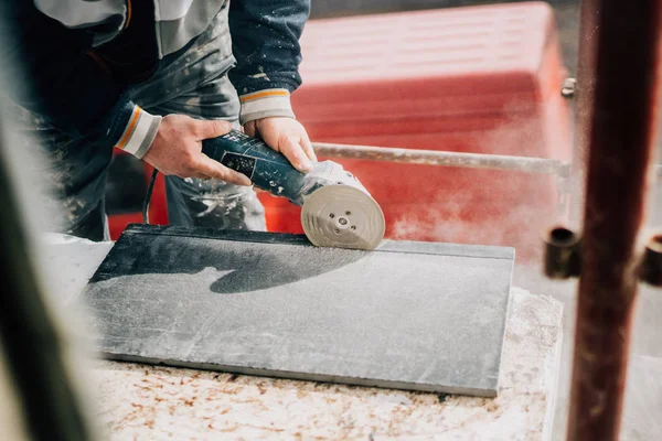 Details of worker cutting stone marble with angle grinder at construction site — Stock Photo, Image