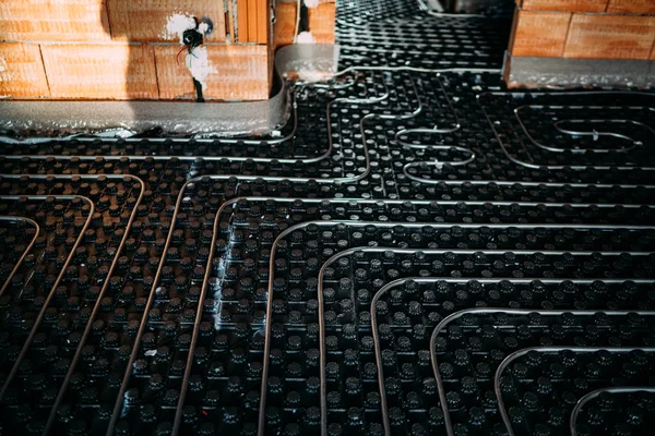 Деталі будівництва нового будинку - установка труб та аксесуарів для системи теплопостачання підлоги — стокове фото