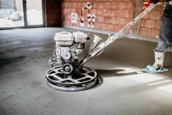 Worker using power trowel for screed on construction site — 스톡 사진