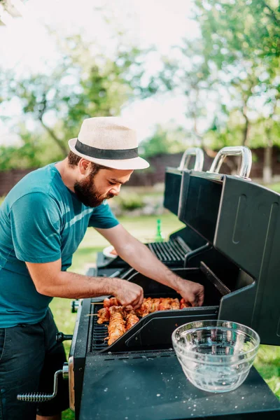 Primer plano del hombre cocinando a la parrilla, tomando cervezas y cocinando en la barbacoa del jardín. Estilo de vida, concepto de ocio —  Fotos de Stock