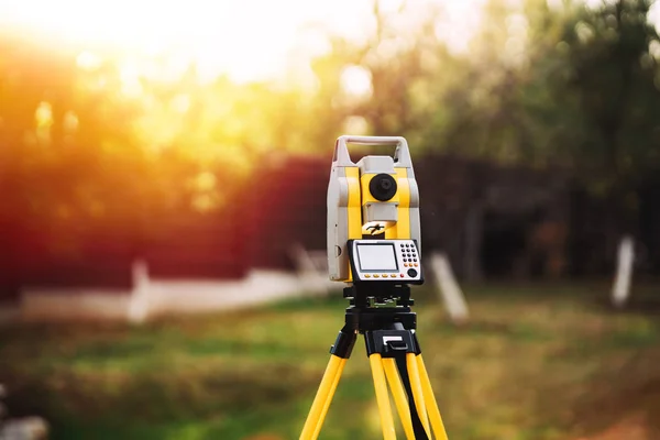 Equipamento de engenharia topógrafo com teodolite e estação total em um jardim — Fotografia de Stock