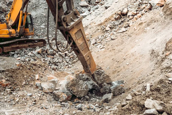 close up details of excavator scoop and iron breaker on construction site