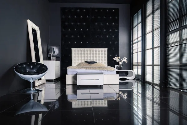 Stylish luxury bedroom interior design with dark walls and modern light furniture