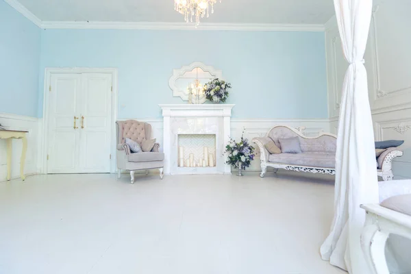 Luxury light interior design with elegant vintage furniture and floral decorations