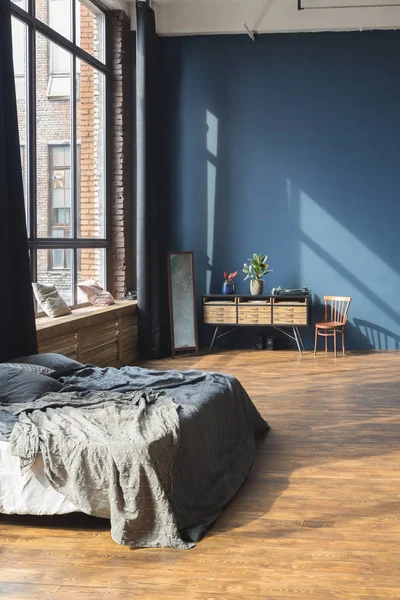 Modern interior design of studio apartment with wooden furniture
