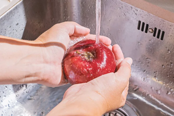 Mãos femininas lavar maçã — Fotografia de Stock