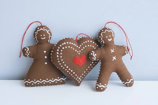 Gingerbread couple with big heart decoative cookies for Christmas tree. Soft handmade toys. Relationship and love Valentine\'s day. Do it yourself concept