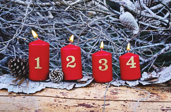 Four red advent candles with number as Catholic symbol of Christmas. Christmas decoration with burning candles for advent time