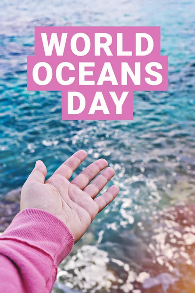 WORLD OCEANS DAY on surface of ocean water