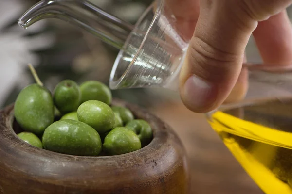 Wooden Cup Olives Extra Virgin Olive Oil Glass Bottle Hand — Stock Photo, Image