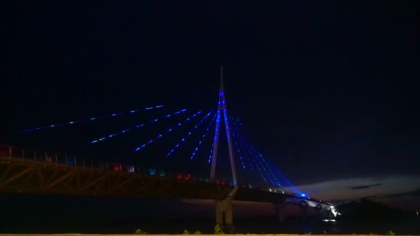 Colorful bridge, shimmering with different colors at night — Stock Video