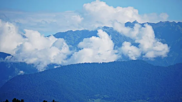 Mountain peak range landscape. Green mountain range view. Mountain peak blue sky white clouds panorama