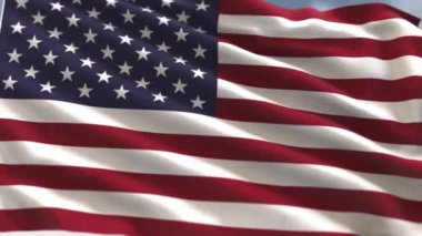 Rüzgarda dalgalanan Amerikan Bayrağı mavi bir arka planda.