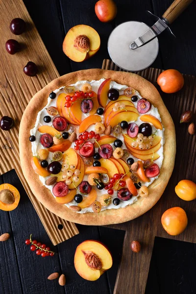 Homemade healthy dessert. Fruit pizza with raw peaches, apricots