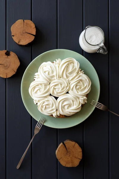 Healthy low sugar cake with coconut cream roses on dark backgrou