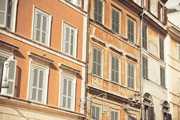 Facade painted in orange of a traditional italian house