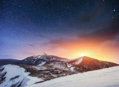 Fantastik kış meteor yağmuru ve karla kaplı dağlar.