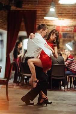 Genç bir çift beyaz bir arka plan üzerinde dans ediyor. Tutkulu salsa