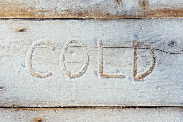 Writing on the snow. Wooden texture. Symbols on wooden board.