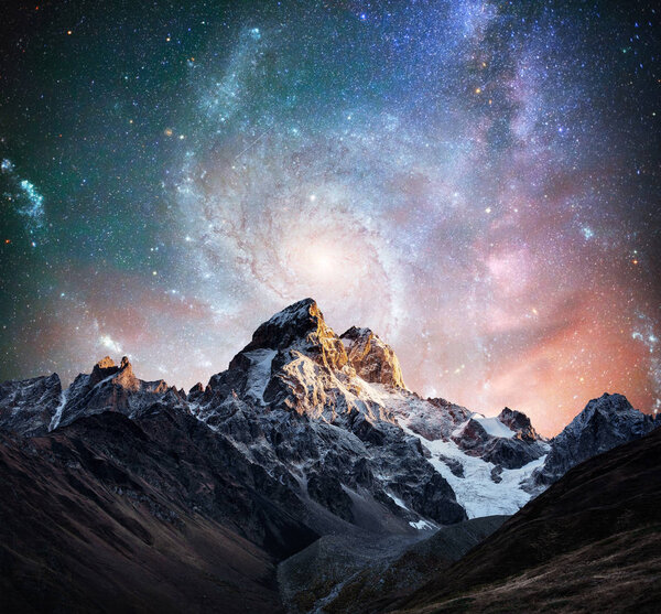 Fantastic starry sky. Snow-capped peaks. Main Caucasian Ridge. Courtesy of NASA. Mountain View from Mount Ushba Meyer, Georgia. Europe.