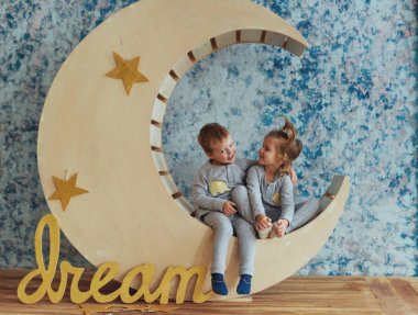 Çocuk yalan yumuşak ve sıcak pijama yıldız stüdyo ile ahşap bir ay. Uyku zaman kavramı