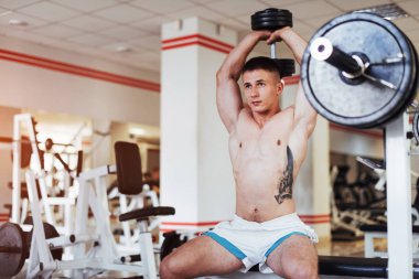 Spor salonunda ağırlık ile bir güzel atletik adam kasları portresi. Spor. Fitness