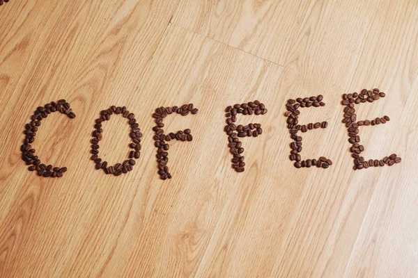 Coffee Phrase Spelled Out Roasted Coffee Beans Wood Background — Stock Photo, Image