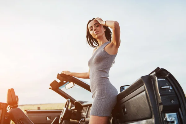 Girls Gladly Posing Next Black Car Sky Fantastic Sunset — Stock Photo, Image