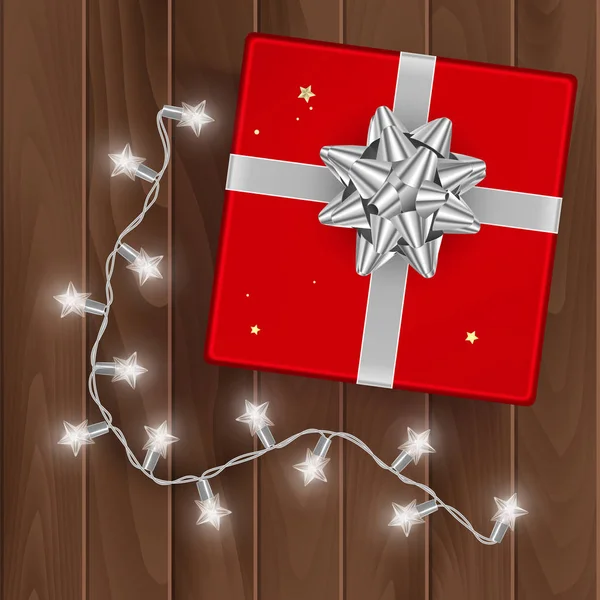 Caja de regalo roja, vista superior, caja de regalo sobre fondo de madera con arco de plata, ilustración vectorial — Vector de stock