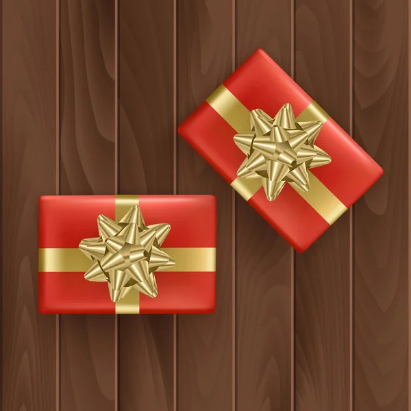 Conjunto de cajas de regalo rojas con cinta dorada realista sobre fondo de madera Vista superior. Regalo de cumpleaños, elemento de decoración navideña. Vector Eps 10 ilustración . — Vector de stock