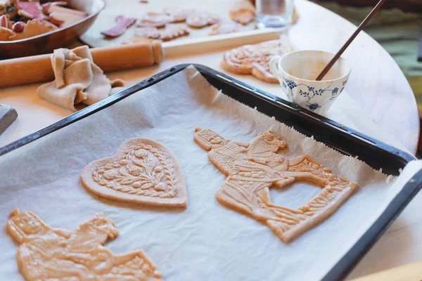 Tradittional home-made gingerbread baking. Egg brushing the ging