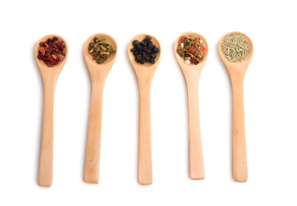 wooden spoon filled with various spices isolated on the white