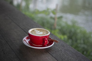 Tahta masada bir fincan latte..