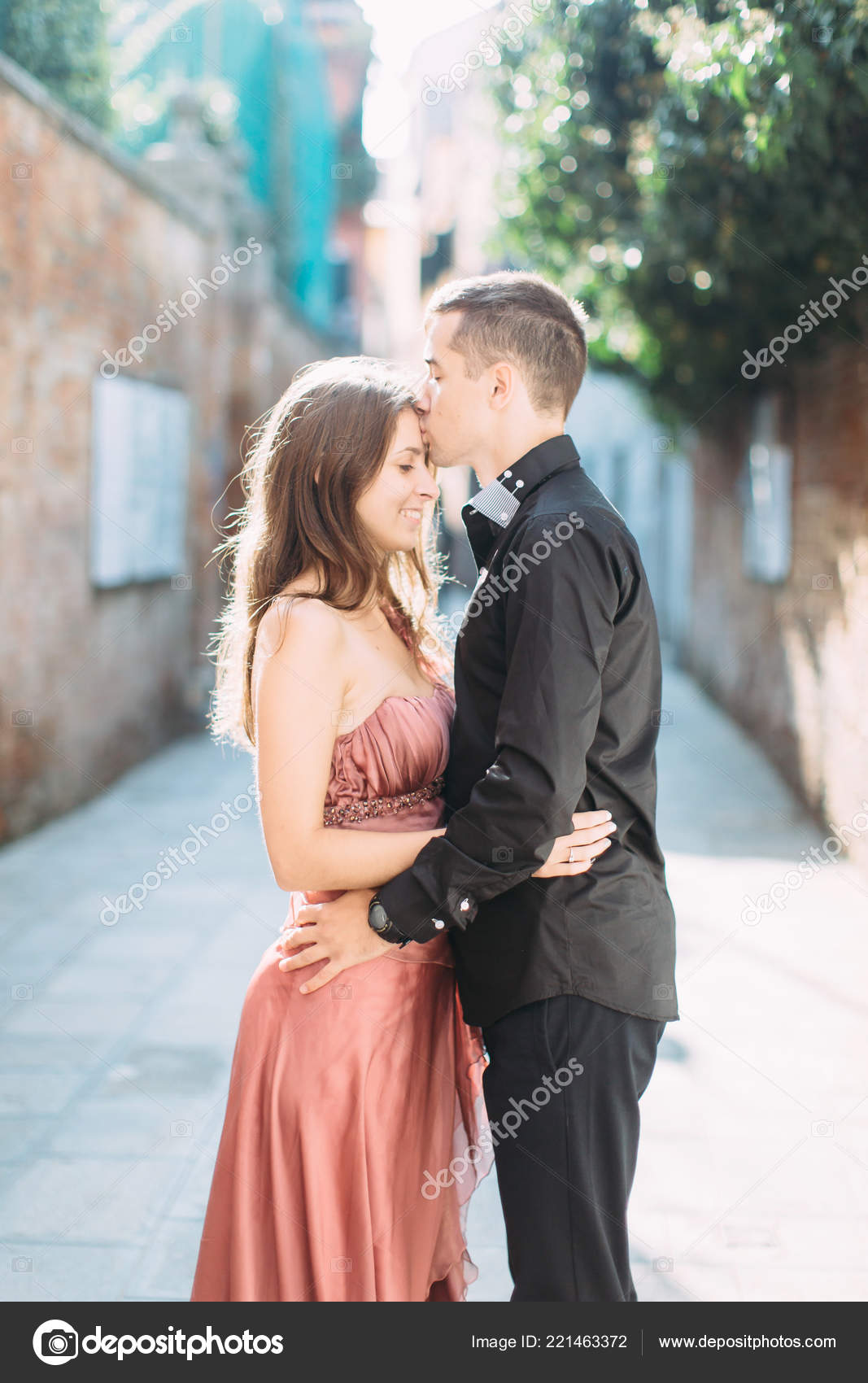 A couple in love on a waterfall. A beautiful girl embraces a man of  athletic build