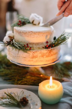 Evli çift kesme düğün pastası çam, çilek ve pamuk çiçek ile dekore edilmiş