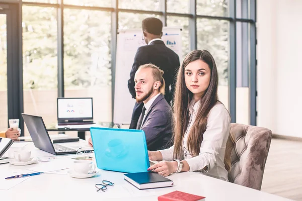 Face of beautiful woman on the background of business people